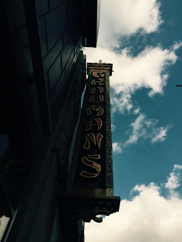 A sign on the side of a building that says ' bakery ' on it