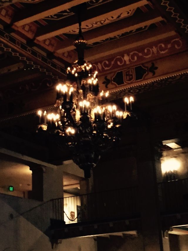 A large chandelier hangs from the ceiling in a dark room