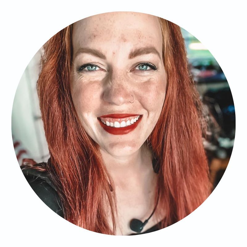 A woman with red hair and freckles is smiling in a circle.