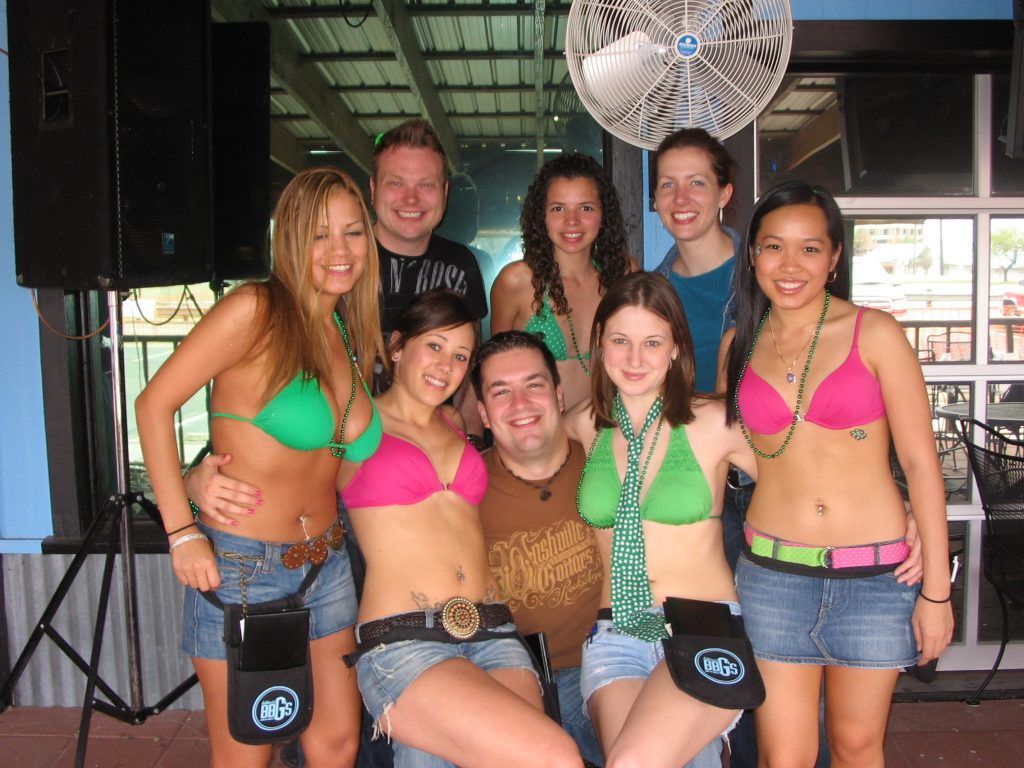 A group of people posing for a picture in front of a fan