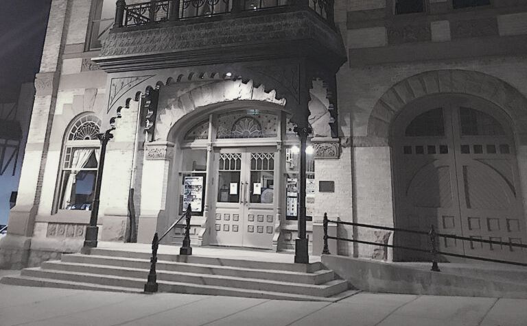 A black and white photo of the front of a building