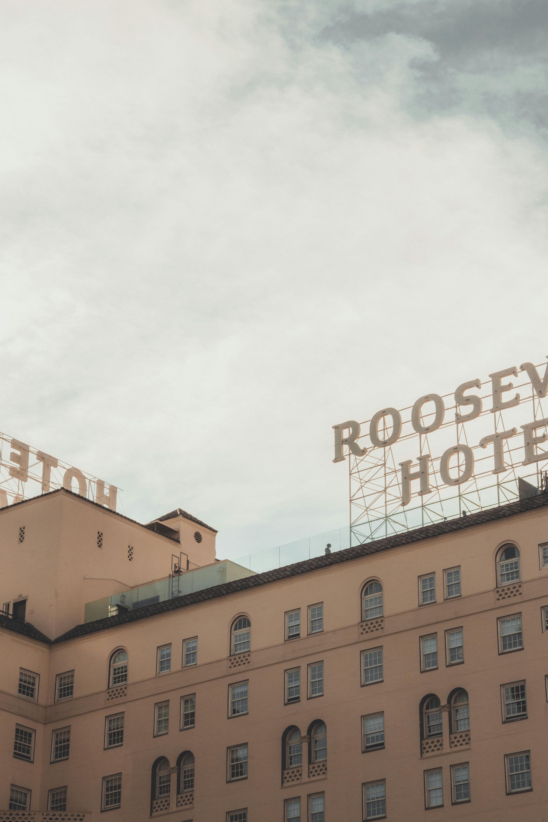 Roosevelt Hotel sign and building with grey sky 