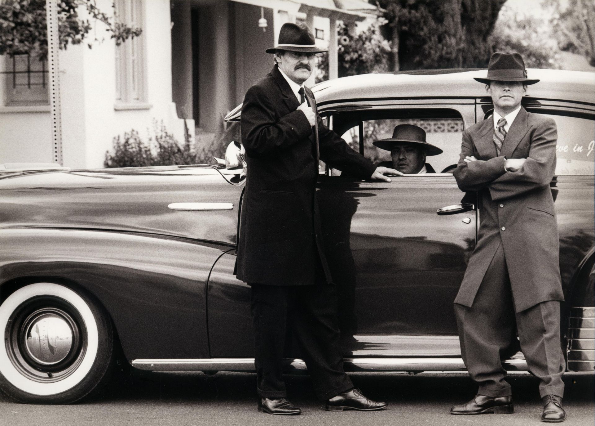 gangsters in front of a car