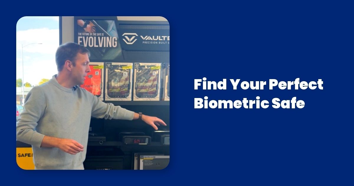 A man is standing in front of a display of biometric safes.