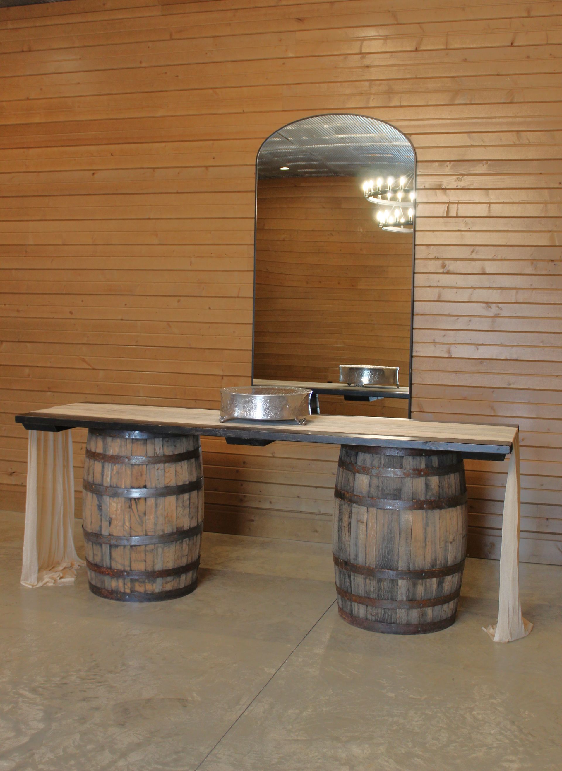 Two wooden barrels with a table top complete a serving table.