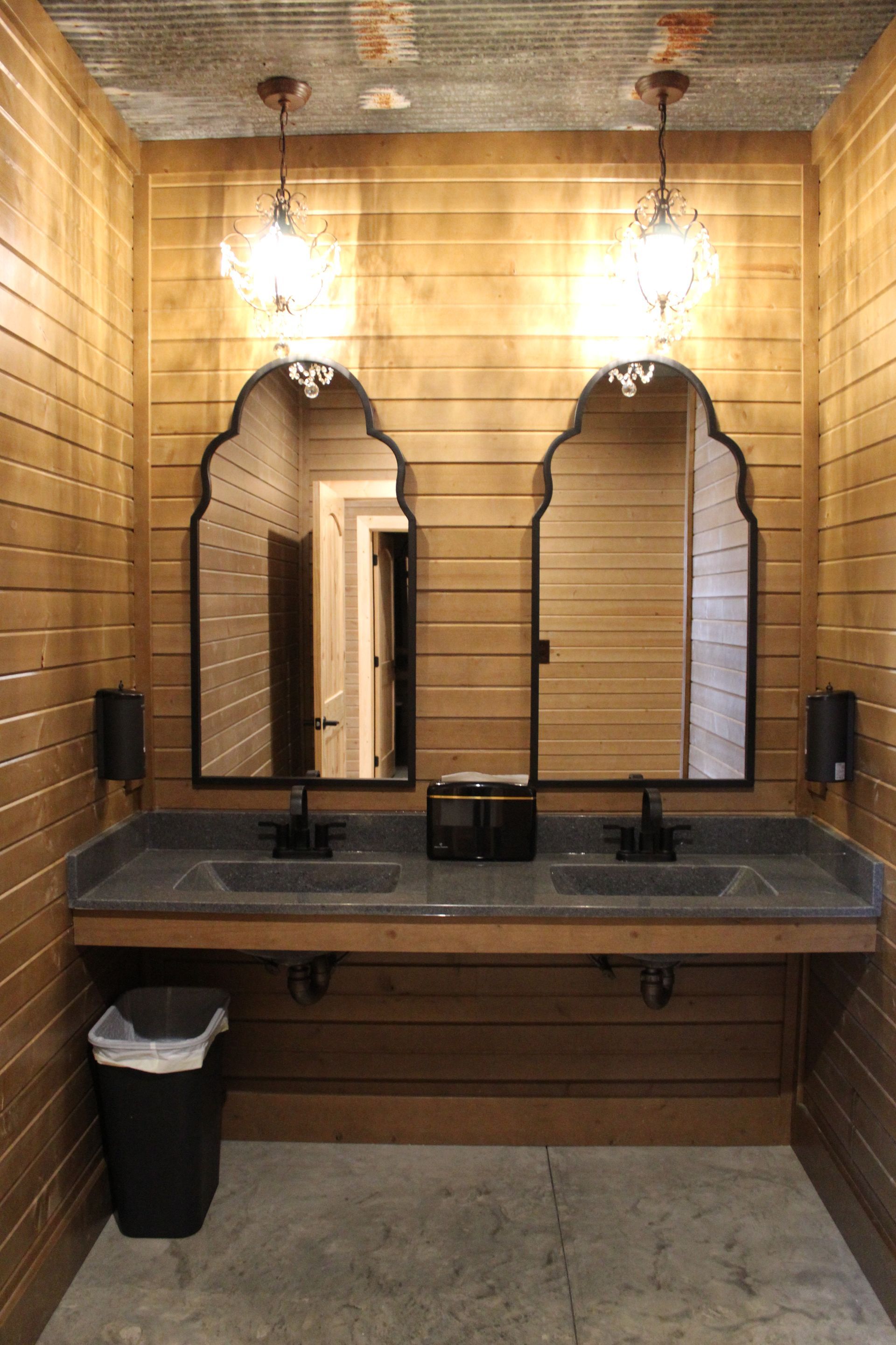 A bathroom with two sinks and two mirrors.