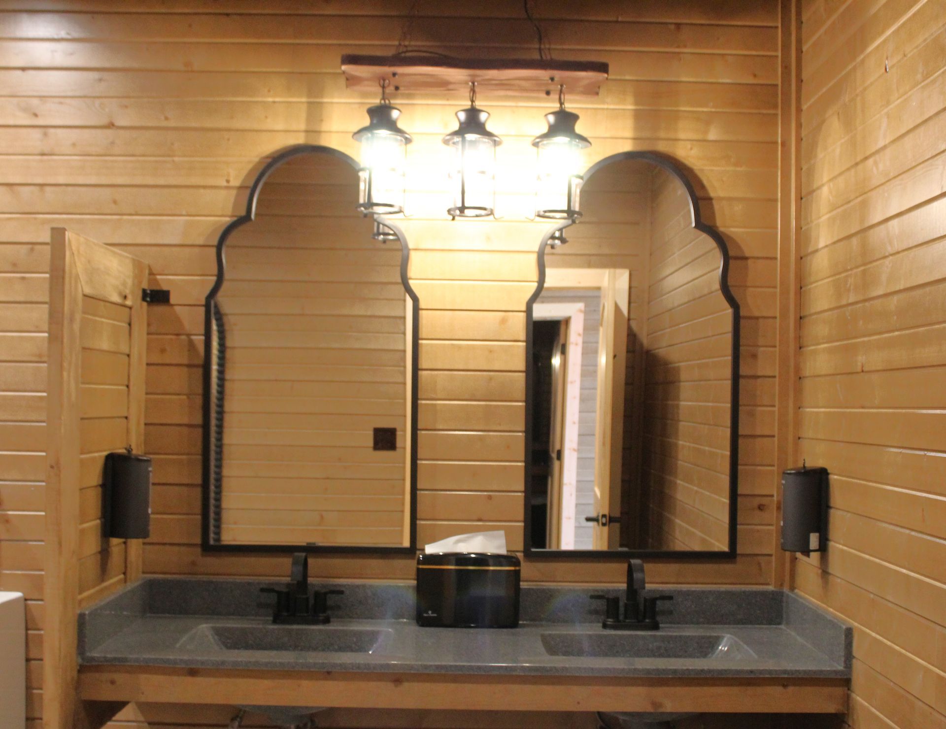 A bathroom with two sinks and two mirrors