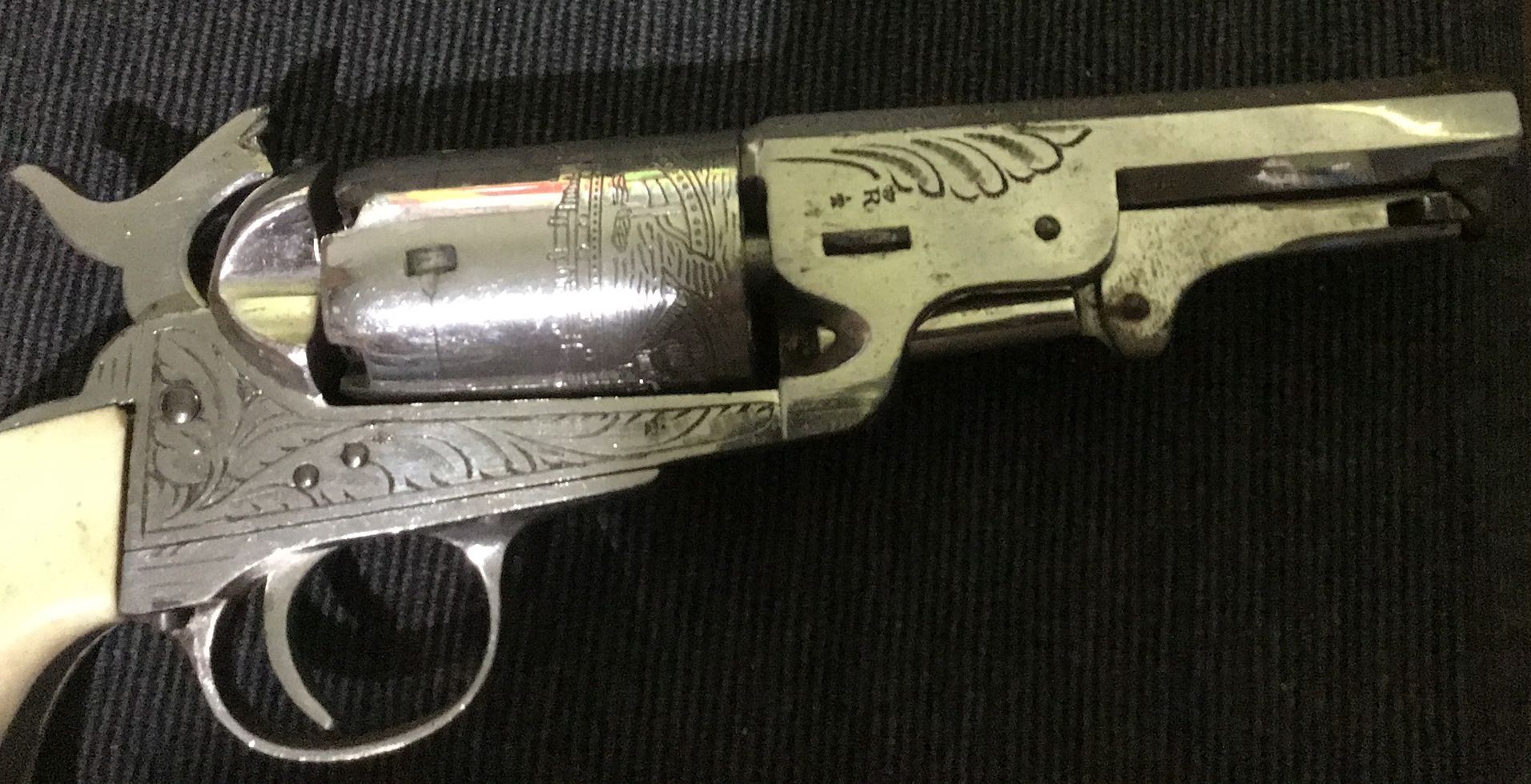 a close up of a revolver with a floral design on it