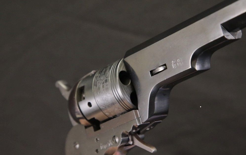 a close up of a revolver with chamfered chamber mouths