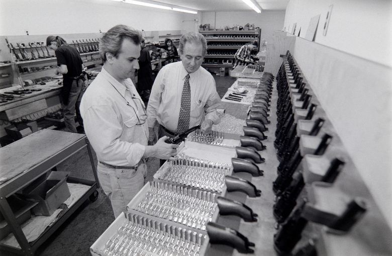 This is Anthony Imperato (left) and his father Louis Imperato (right) nspecting trigger guards at the Colt Blackpowder Arms Co. factory in Brooklyn, NY in May 1995.