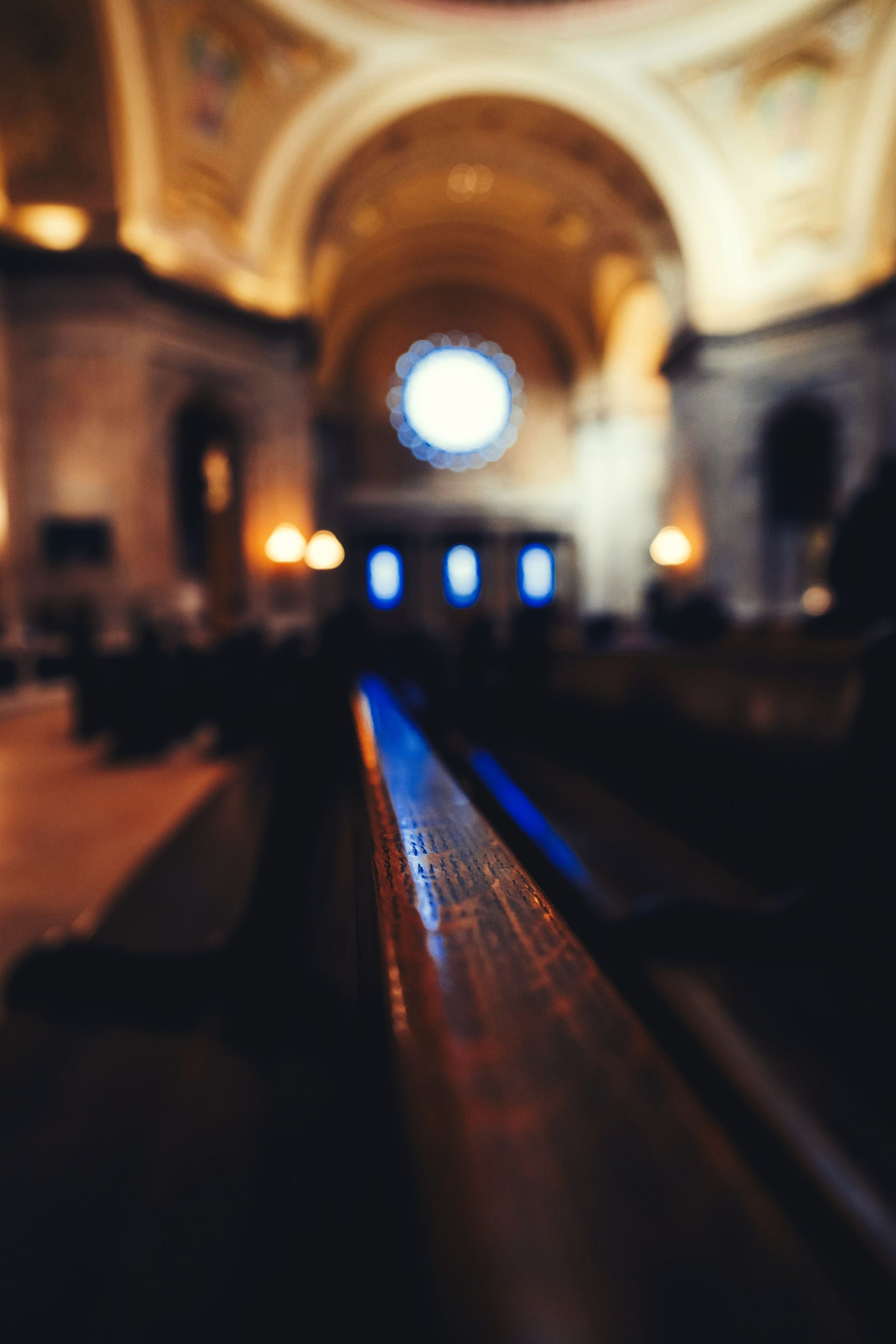 A blurry picture of a church with a blue light coming out of the ceiling.