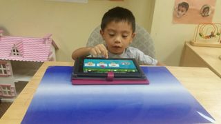 Child Playing on tablet— Elementary Age Children in Jeffersonville PA