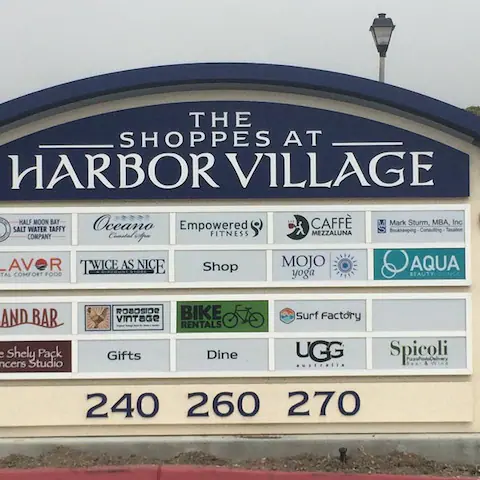 Harbor Village Shopping Mall sign: the list of shops with logos and the phone number 240260270..