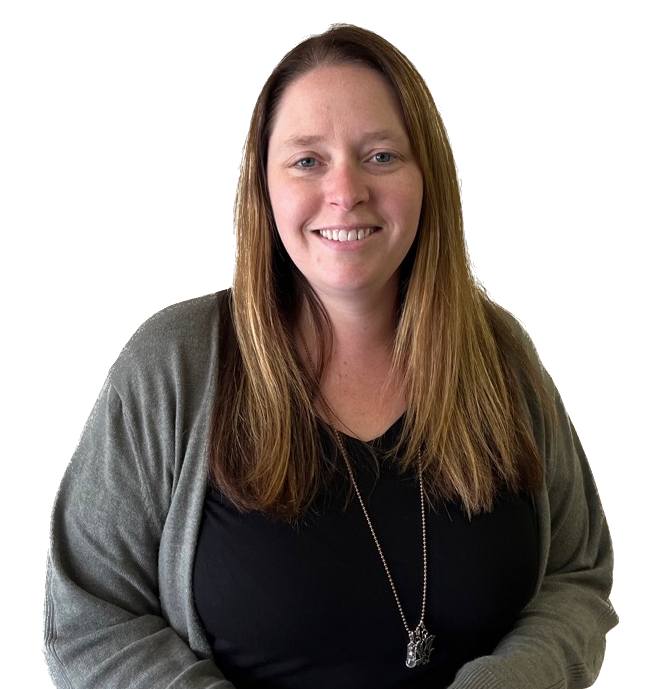 A woman wearing a black shirt and a grey sweater is smiling.