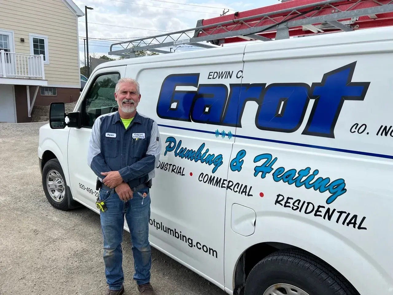 A water heater is sitting on the floor in a basement.
