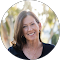 A woman in a black shirt is smiling in a circle.
