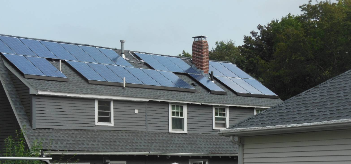 A house with a lot of solar panels on the roof