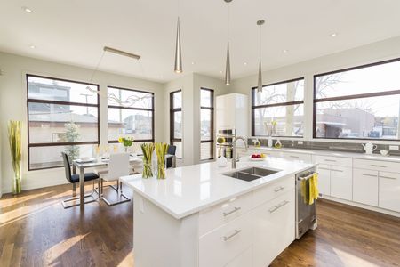 A kitchen with a large island in the middle and lots of windows.
