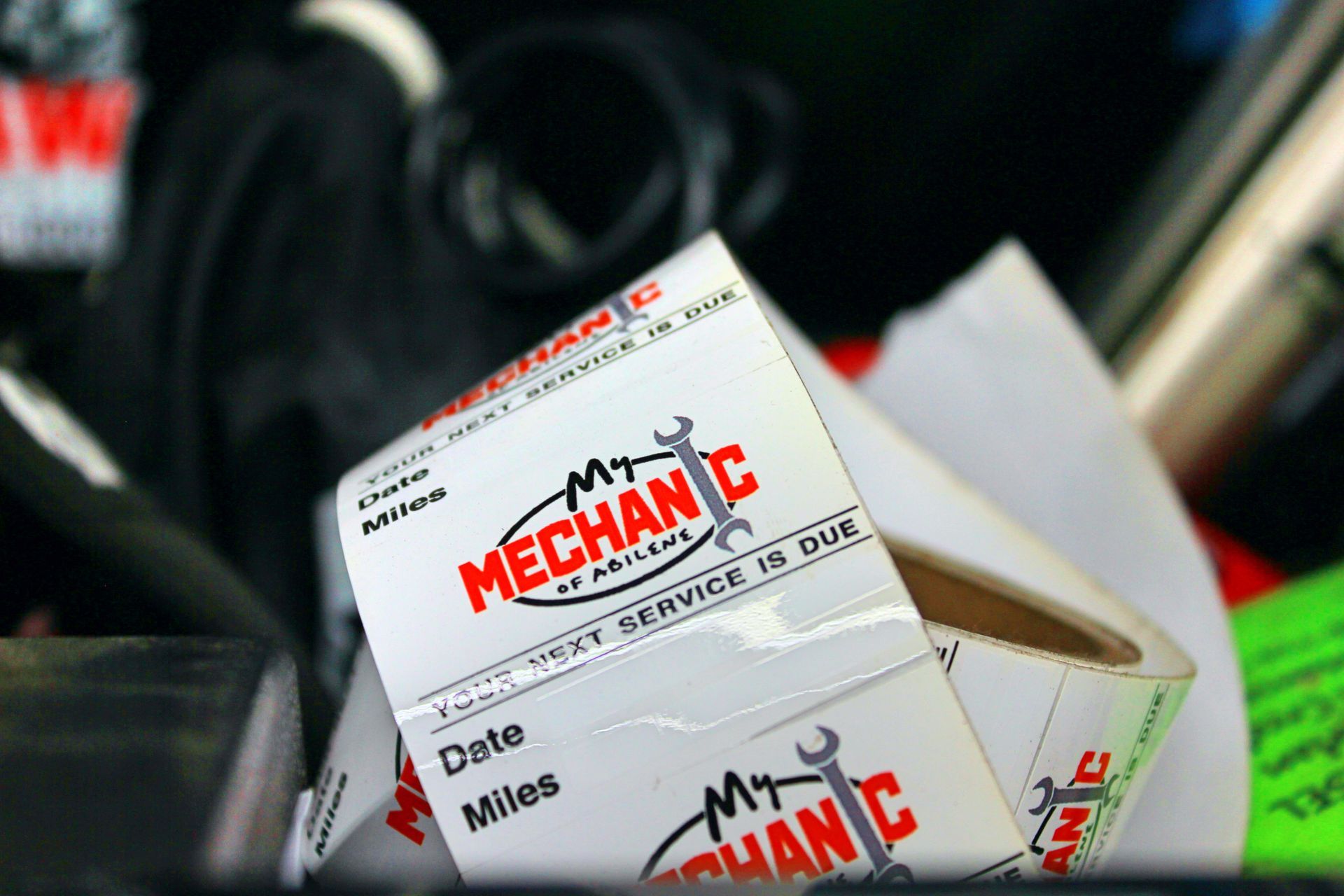 Mechanic working on a car engine in a garage.