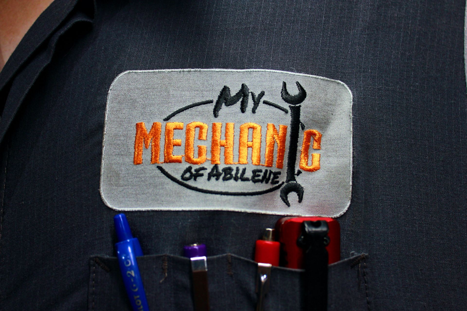 Close-up of a mechanic's uniform pocket with a 
