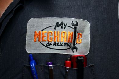 Close-up of a mechanic's uniform pocket with a