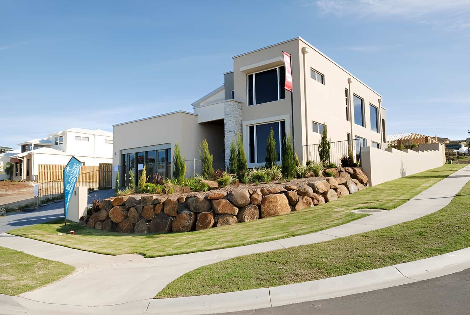 A Large House With a Stone Wall in Front of It — Australian Rock Walls In Burleigh Heads, QLD