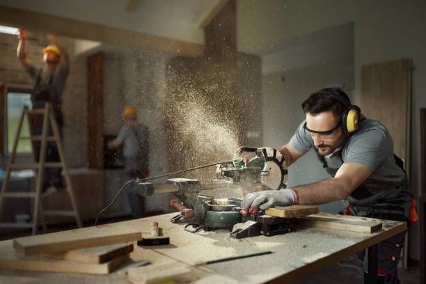 Carpenter cutting wood with a miter saw