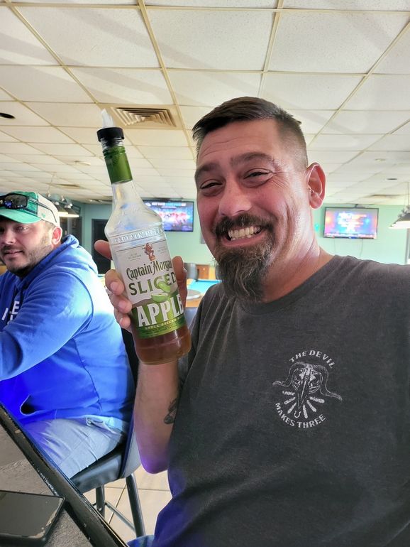 A Man Smiling While Holding Alcohol Drinks | Foley, AL | The Office Lounge A Man Smiling While Holding Alcohol Drinks | Foley, AL | The Office Lounge