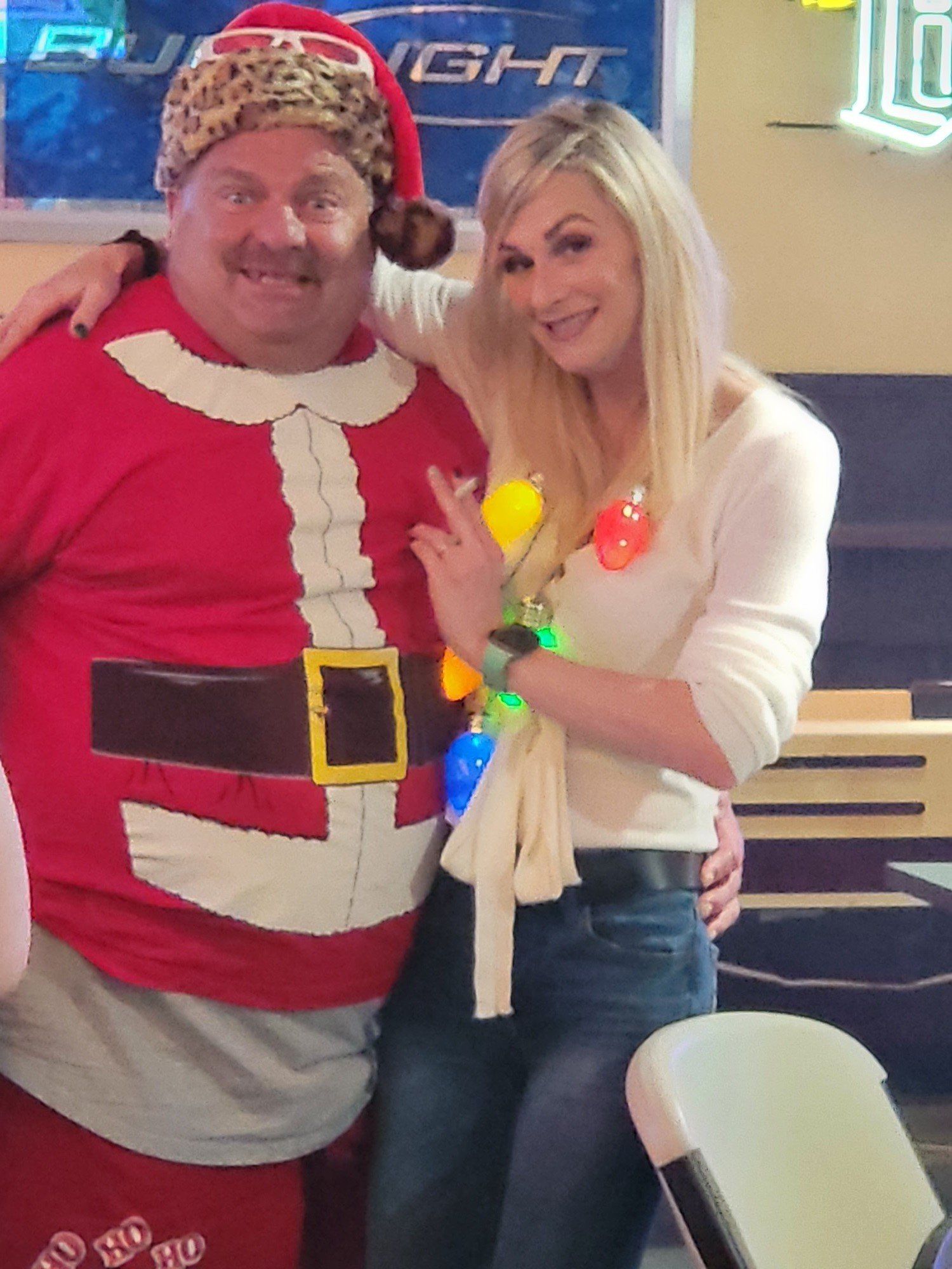 A Girl And His Partner Wearing Santa Claus Costume | Foley, AL | The Office Lounge