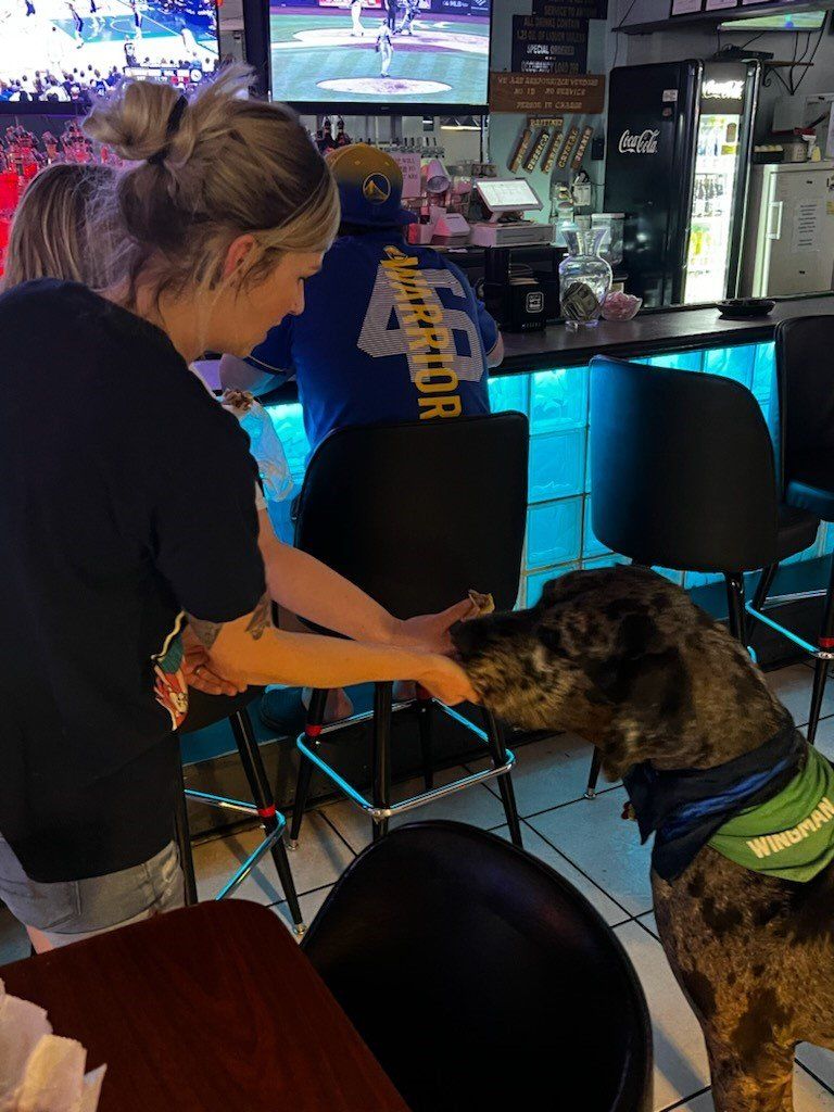 Woman Touching A Dog | Foley, AL | The Office Lounge