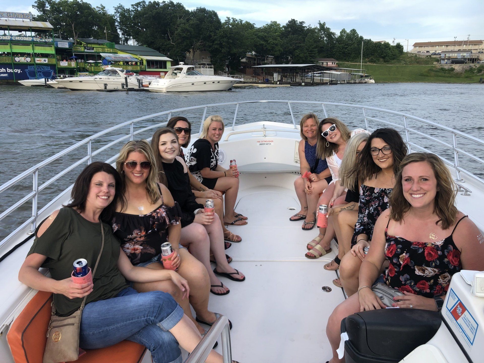 bachelorette party on water taxi with Shady Gators in background at Lake of the Ozarks