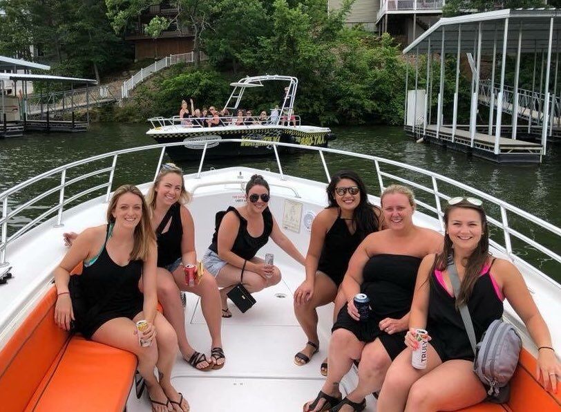 two taxi boats picking up large bachelorette party at Lake of the Ozarks