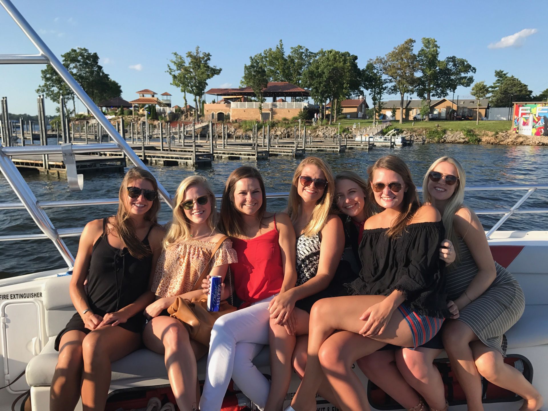 girls posing on boat taxi in front of Shady Gators