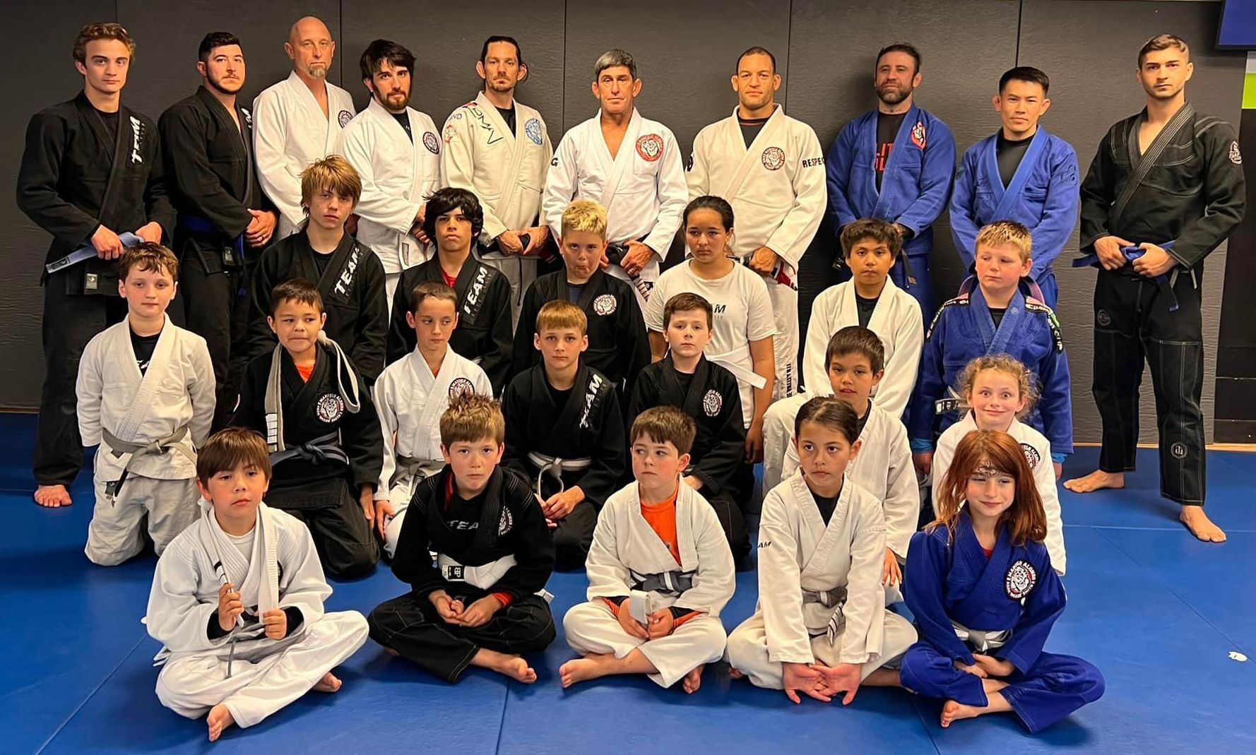 A group of young people in karate uniforms are posing for a picture.
