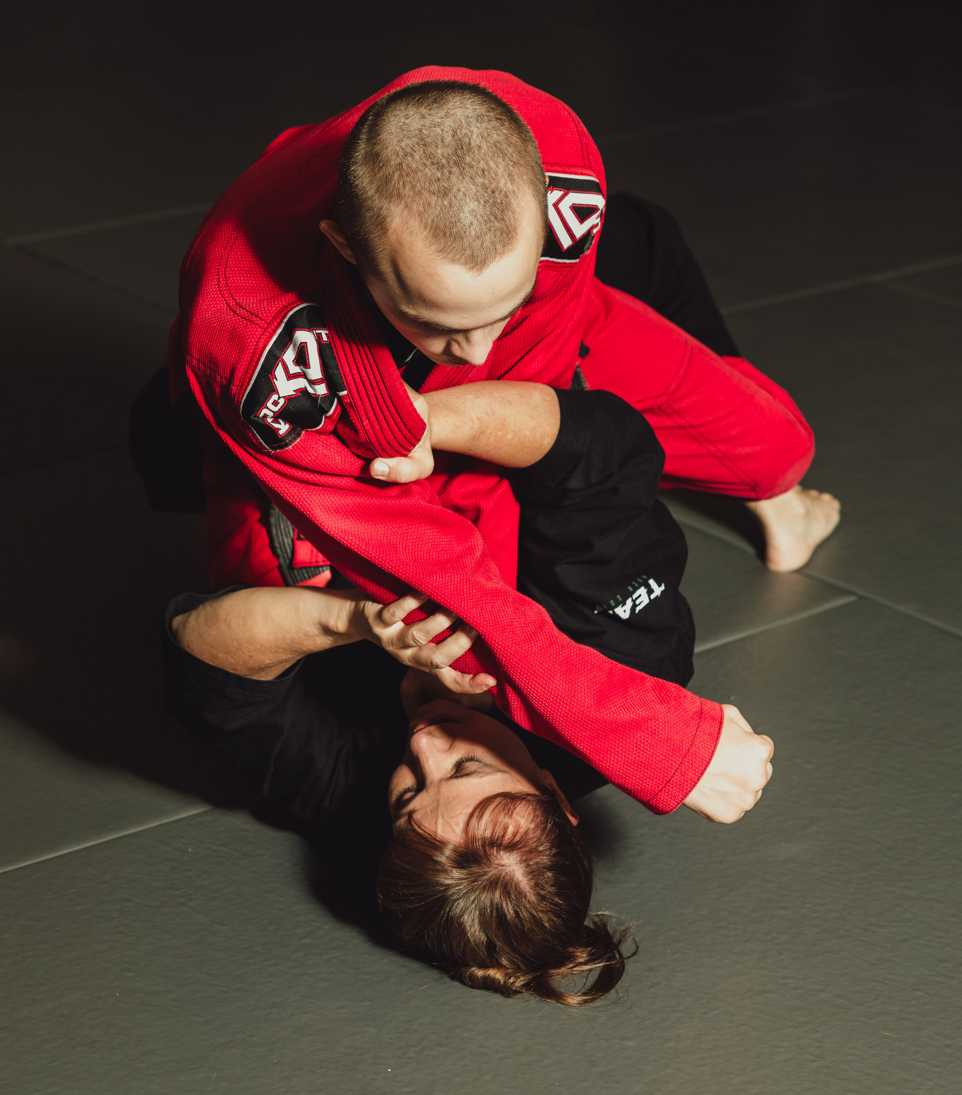 A group of people are standing around a mannequin in a room