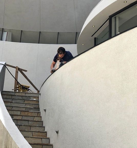 A man climbs up a set of stairs in a building