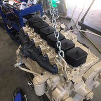 A diesel engine is being worked on in a garage.