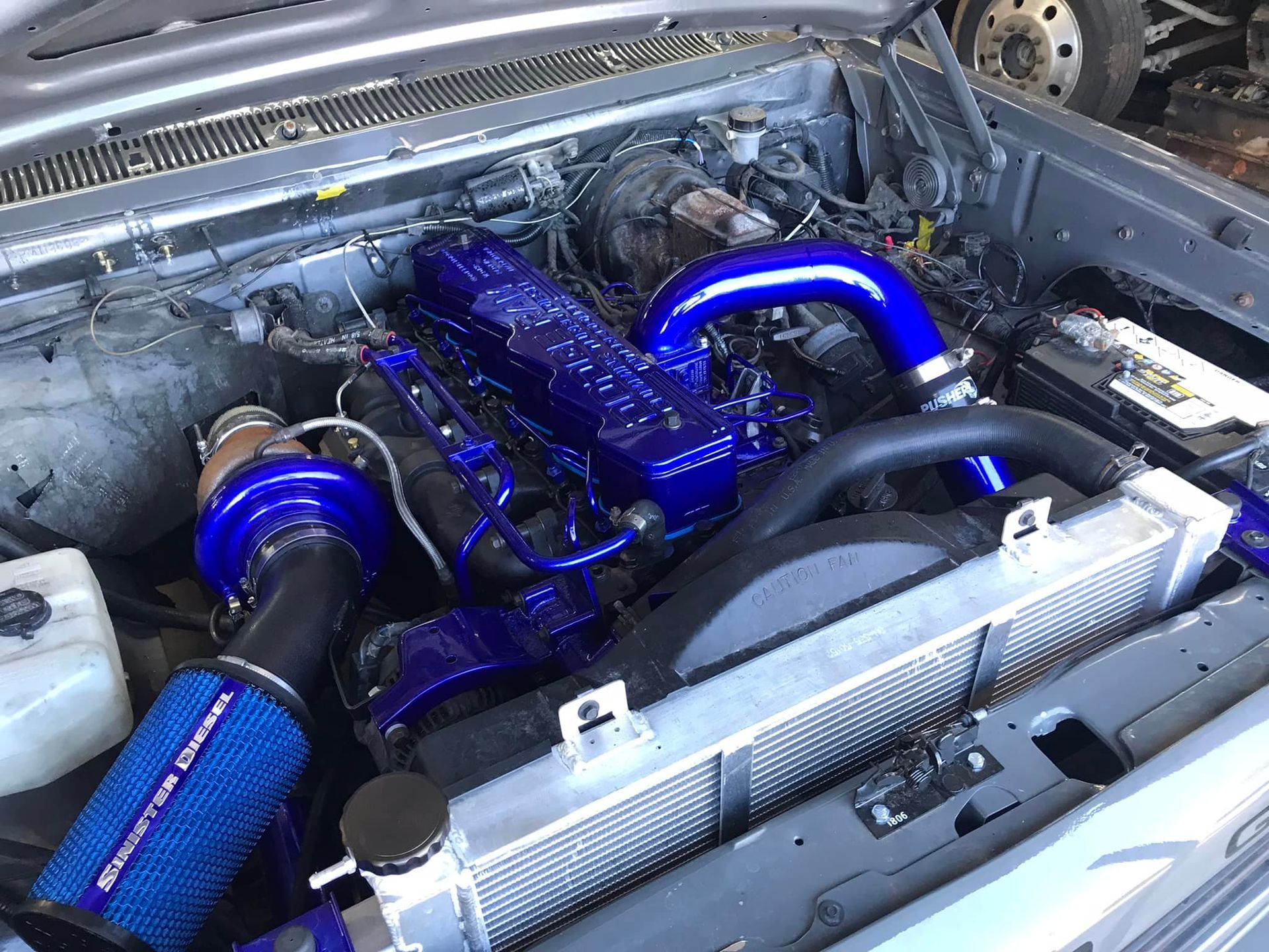 A close up of a car engine with blue pipes