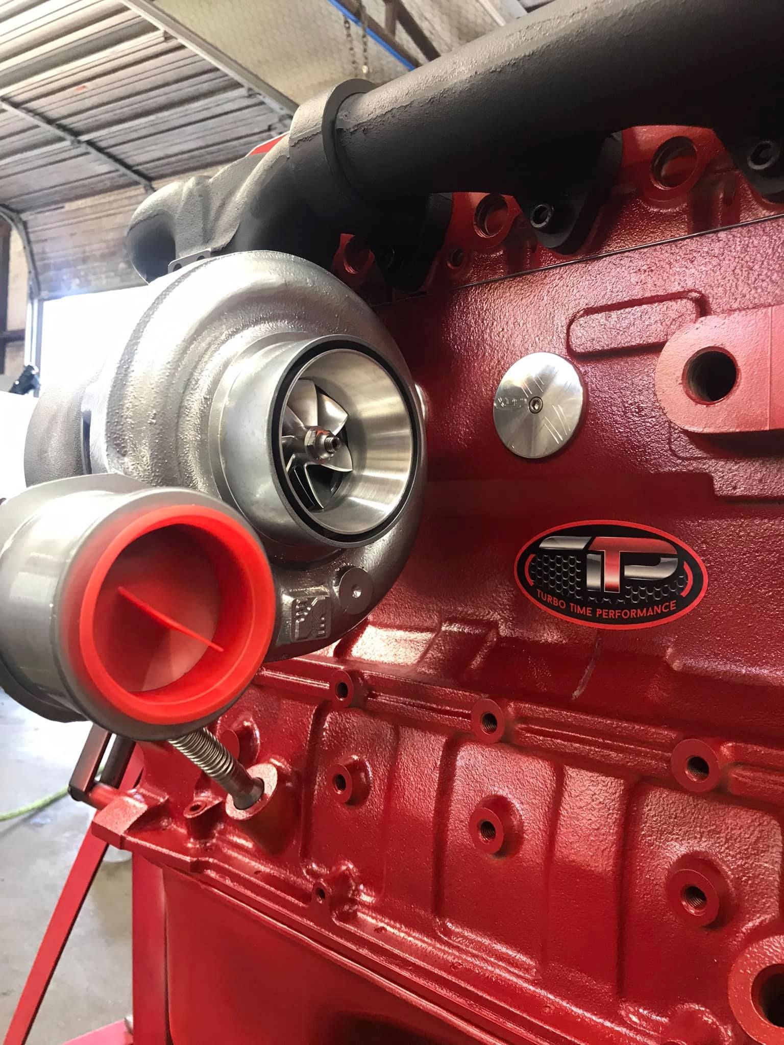 A red engine with a turbocharger attached to it.