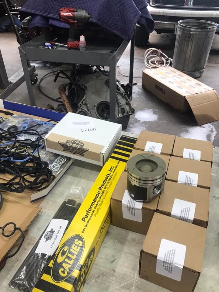 A bunch of boxes are sitting on a table in a garage.