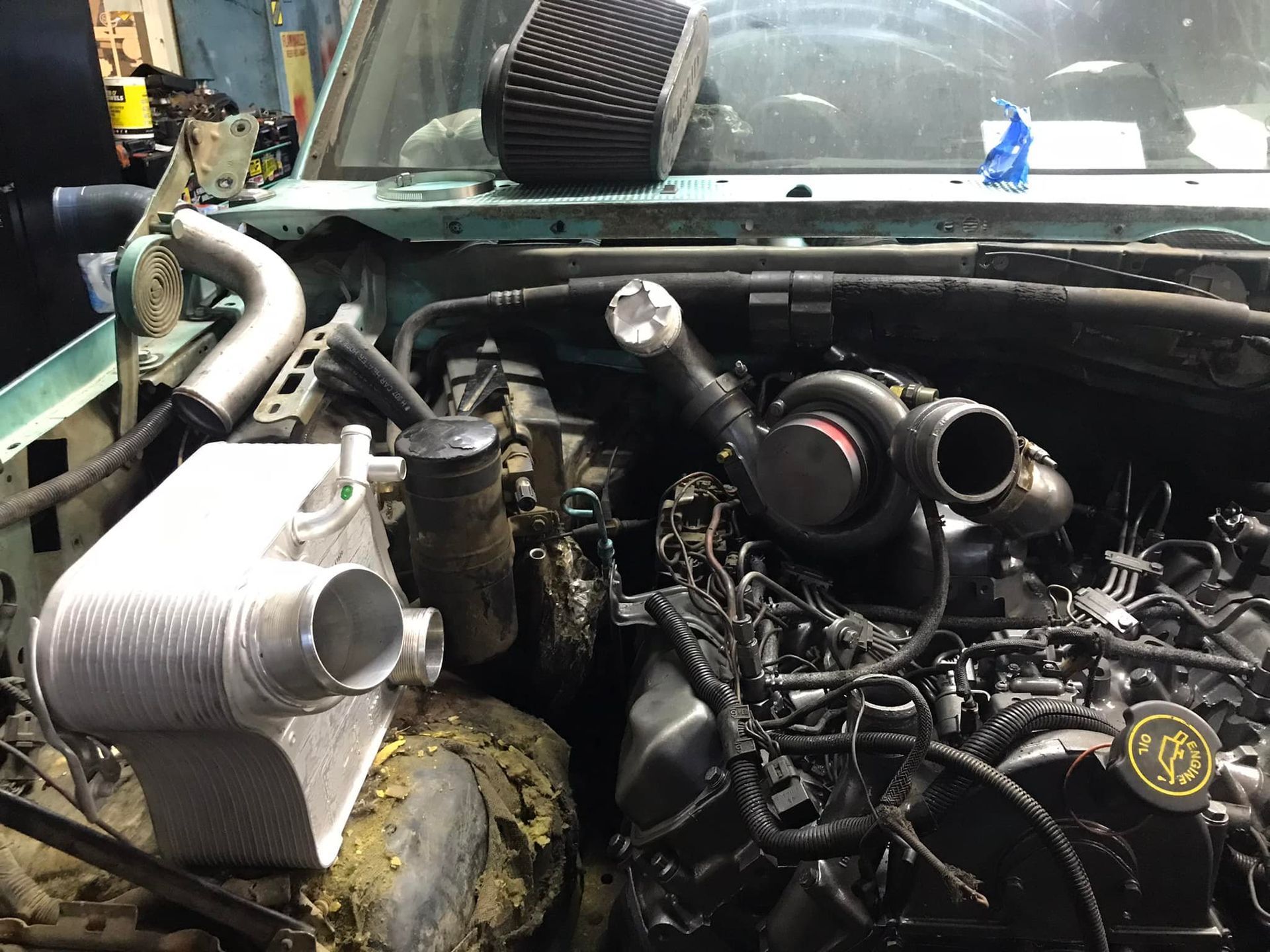 A car engine is being worked on in a garage