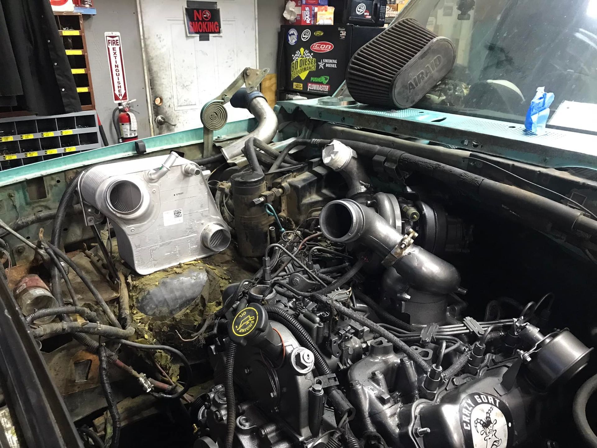 A car engine is being worked on in a garage.