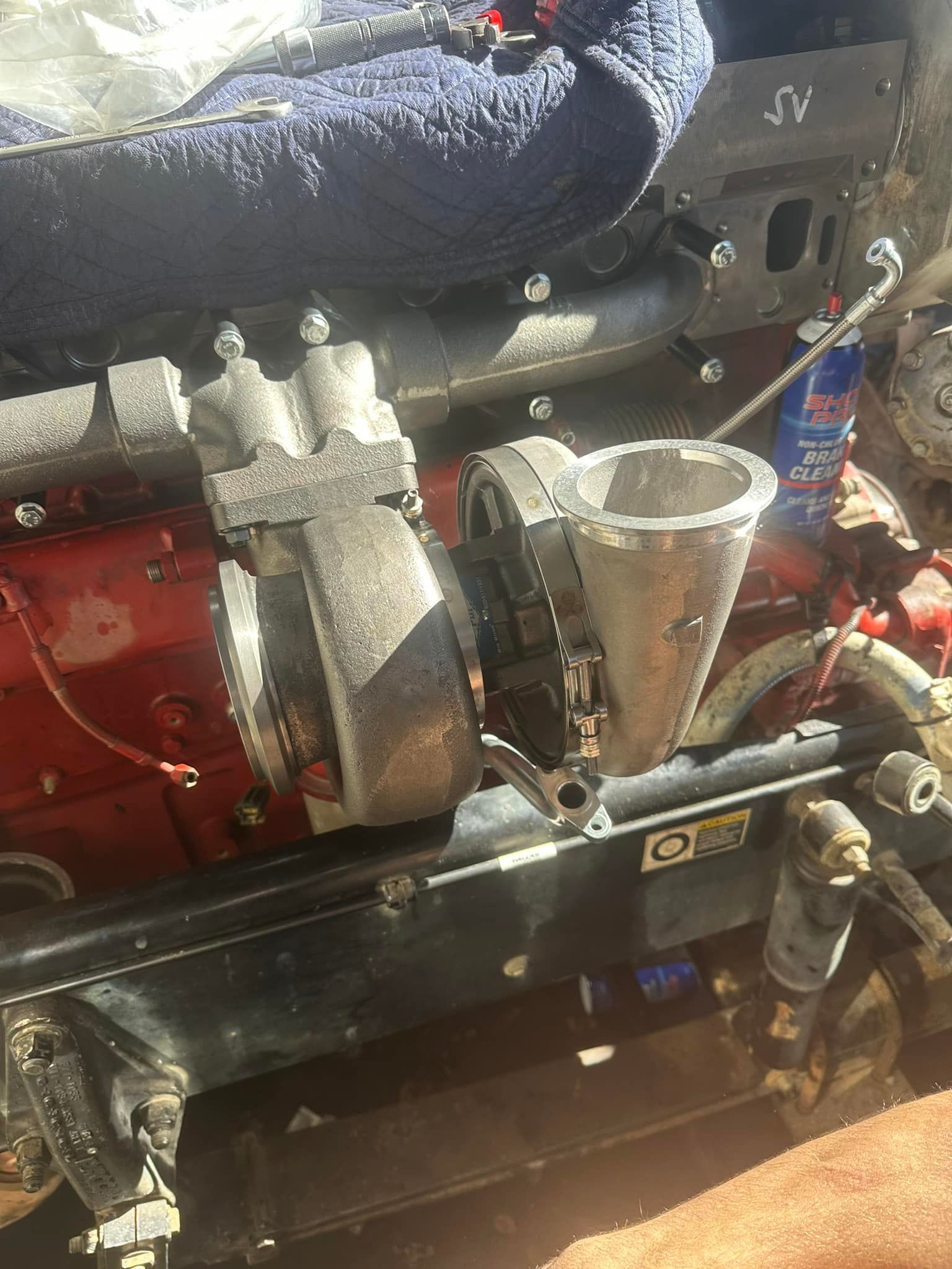 A close up of a turbocharger on a car engine.