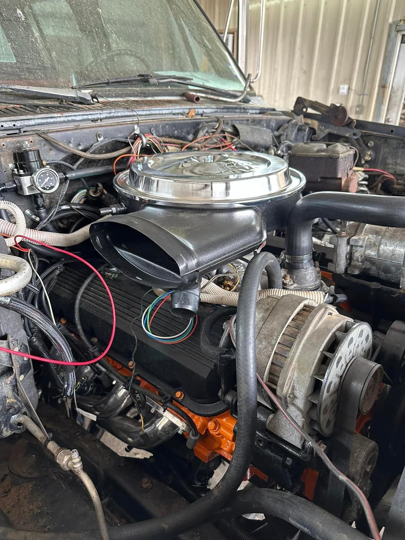 A close up of a car engine in a garage.