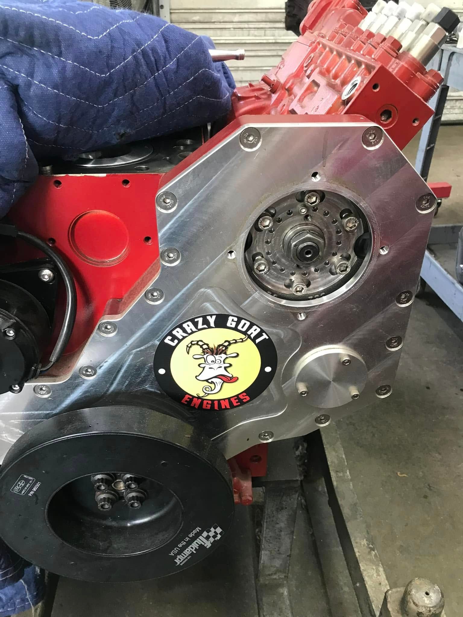 A red engine with a sticker on it is sitting on a table.