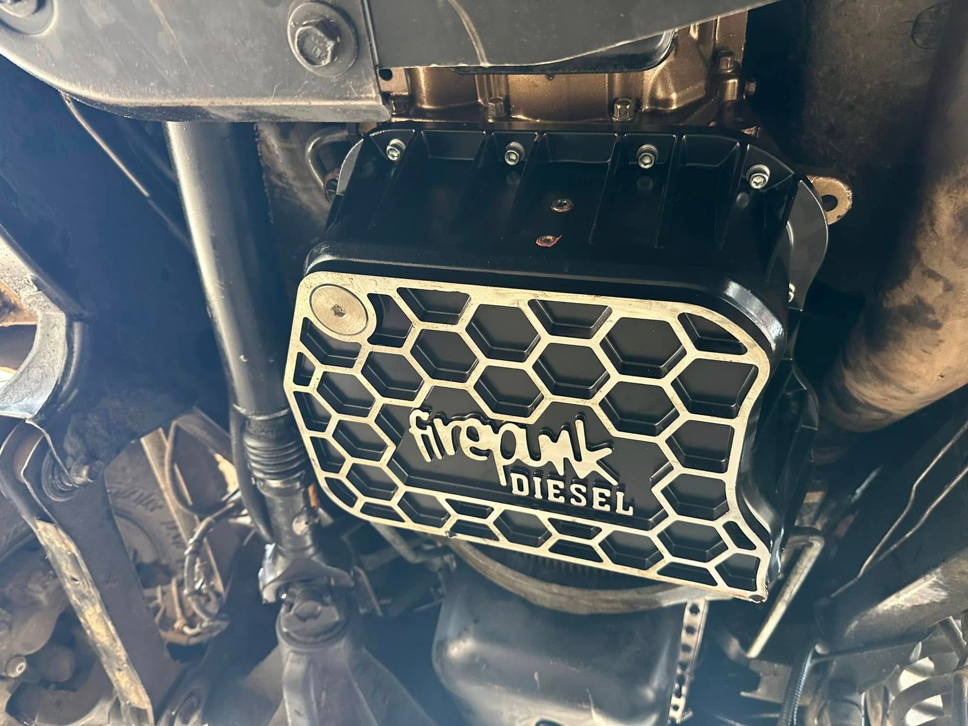 A close up of a diesel engine with a honeycomb design on it.