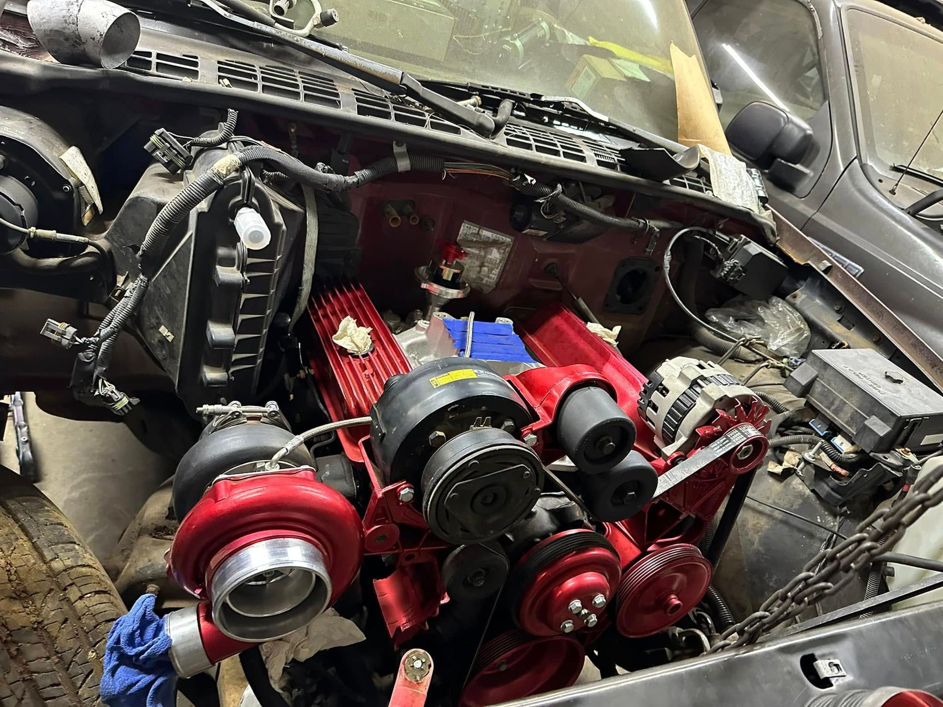 A car engine is being worked on in a garage