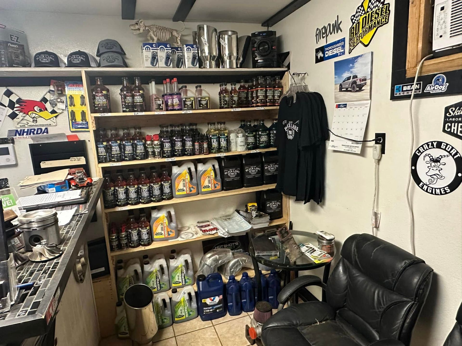 A room filled with shelves filled with bottles of oil and a chair.
