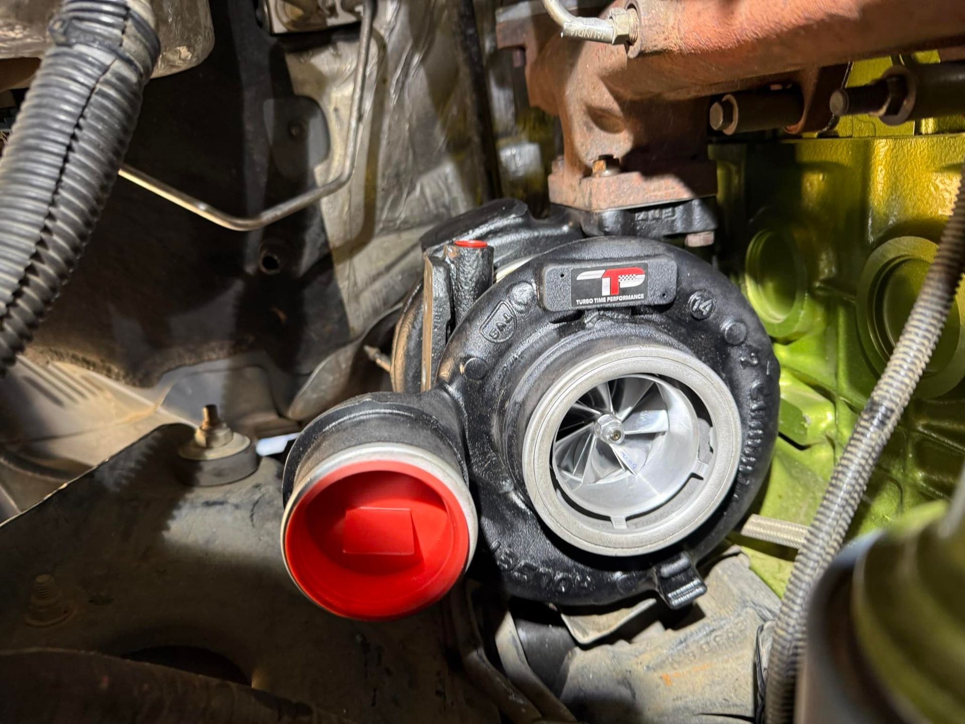 A close up of a turbocharger on a car engine.