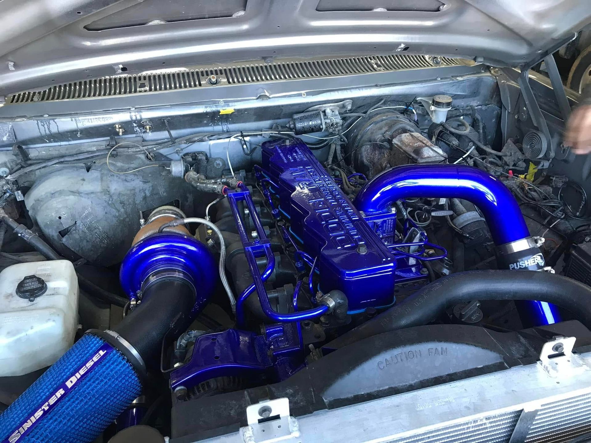 A close up of a car engine with blue pipes